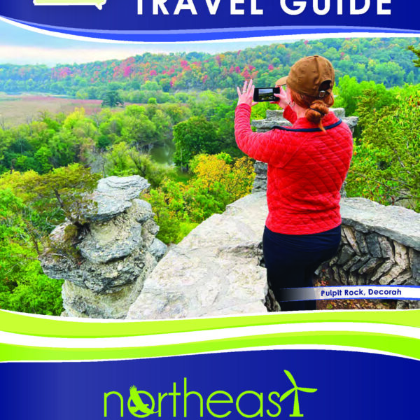 Image of a brochure for the Northeast Iowa Tourism Association showing a woman taking a picture of a scenic overlook.