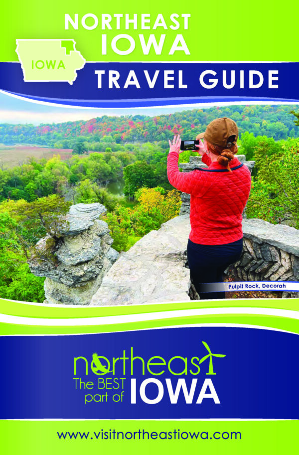 Image of a brochure for the Northeast Iowa Tourism Association showing a woman taking a picture of a scenic overlook.